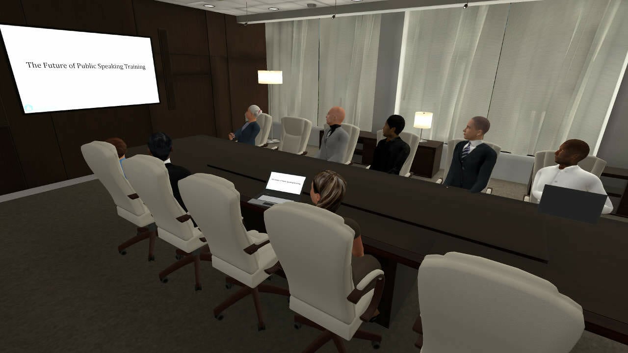 En bild av ett mötesrum med människor som har ett möte i det